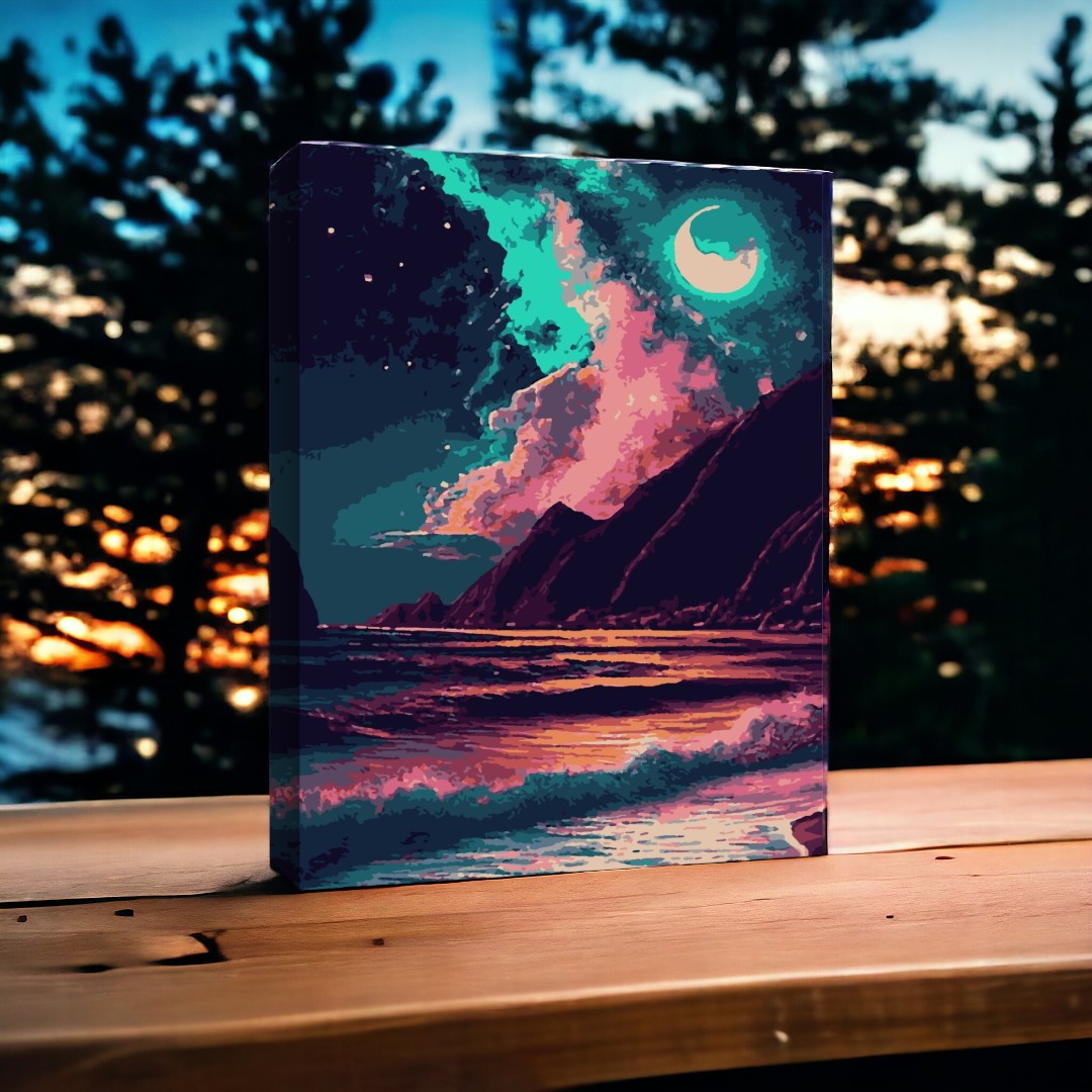 Une toile représentant une scène nocturne colorée avec des montagnes, un ciel étoilé et la mer, posée sur une table en bois à l’extérieur.